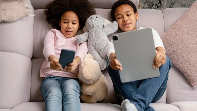 siblings-using-tablet-mobile-home